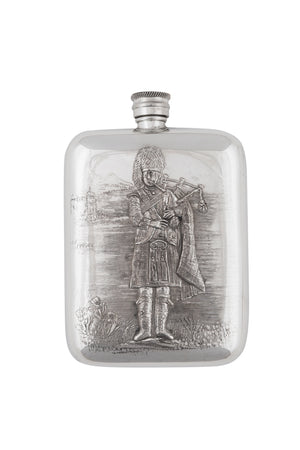 A hip flask made from pewter Featuring the Scottish Piper and his bagpipes.