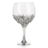 Botanical Gin glass handmade with pewter showing floral designs around the base of the glass.