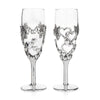This specific design consists of TWO champagne glasses with a beautiful pewter lovebirds design clinging to them.