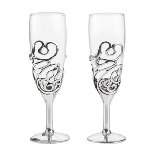 TWO champagne glasses with a beautiful pewter swirl clinging to them.